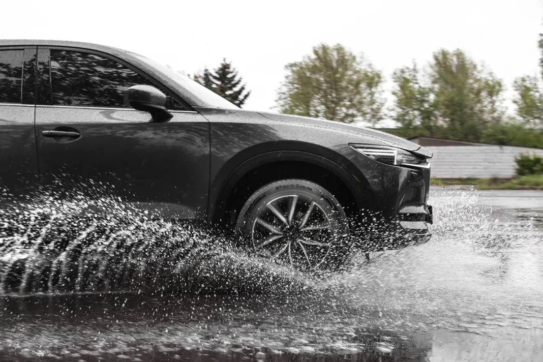 Modern,Car,Driving,Outdoors,On,Rainy,Day